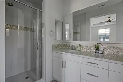 a white bathroom with a shower and a sink at Fun In The Sun 2 Bed 2 Bath Home in Oceanside