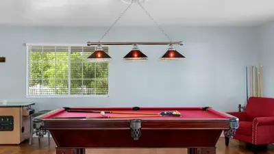 a pool table in a living room with two lights at Wine Country Retreat Gorgeous Views Minutes to Wineries in Temecula