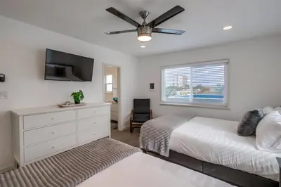 a bedroom with a bed and a ceiling fan at Mermaid's Penthouse in San Diego