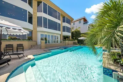 a swimming pool in front of a building at La Jolla Top Of The World Mansion in San Diego