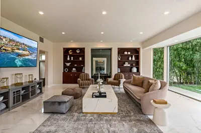 a living room with a couch and a tv at La Jolla Top Of The World Mansion in San Diego