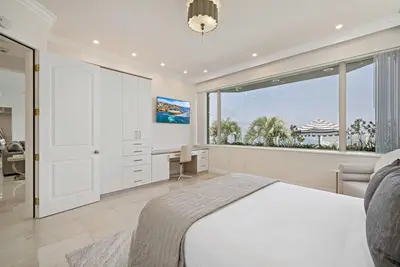 a bedroom with a bed and a desk and a window at La Jolla Top Of The World Mansion in San Diego