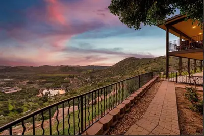 a balcony of a building with a view of a mountain at Breathtaking Retreat in Escondido
