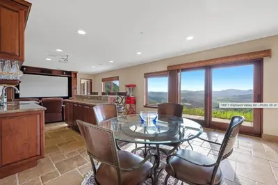 a kitchen and dining room with a glass table and chairs at Breathtaking Retreat in Escondido
