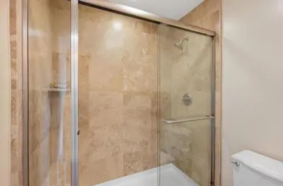 a shower with a glass door in a bathroom at Breathtaking Retreat in Escondido