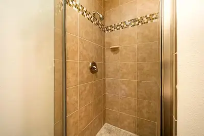 a bathroom with a shower with a glass door at Charming Home Just Steps from the Beach 2 Bedroom, Private Back Patio, & Free WiFi in Newport Beach