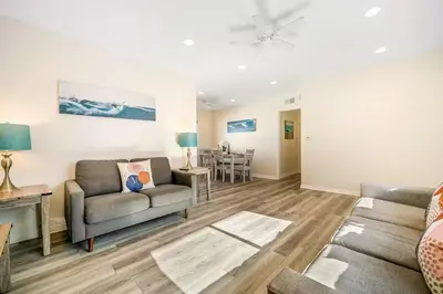 a living room with a couch and a table at Charming Home Just Steps from the Beach 2 Bedroom, Private Back Patio, & Free WiFi in Newport Beach