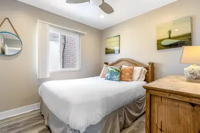 a bedroom with a bed and a window at Stunning 2nd Floor Beachfront Home with Balcony, Ocean Views, and Prime Location in Newport Beach