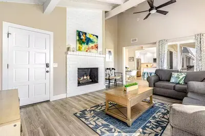 a living room with a couch and a fireplace at Stunning 2nd Floor Beachfront Home with Balcony, Ocean Views, and Prime Location in Newport Beach