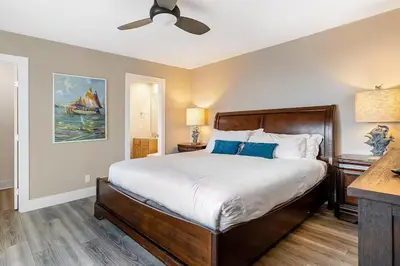 a bedroom with a bed and a ceiling fan at Beachside Oasis in Newport Beach Steps to Balboa Park, Pier, and The Fun Zone! in Newport Beach