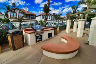 a bench in front of a grill on a sidewalk at Sweet Pea Place, 2 bed with pool in Encinitas