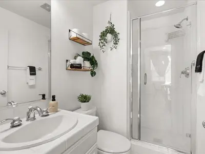 a bathroom with a toilet and a sink and a shower at Irvine Inn Love - Lovely Furnished 3-bed Home in Woodbury in Irvine