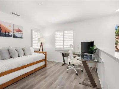 a bedroom with a bed and a desk with a computer at Irvine Inn Love - Lovely Furnished 3-bed Home in Woodbury in Irvine