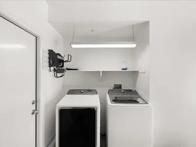 a small white kitchen with a stove and a light at Irvine Inn Love - Lovely Furnished 3-bed Home in Woodbury in Irvine