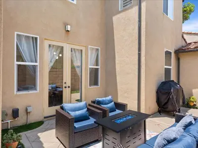 a patio with a couch and chairs and a table at Irvine Inn Love - Lovely Furnished 3-bed Home in Woodbury in Irvine