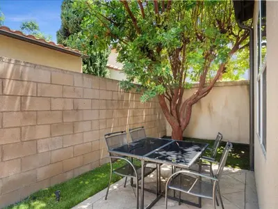 a table and chairs sitting in front of a tree at Irvine Inn Love - Lovely Furnished 3-bed Home in Woodbury in Irvine
