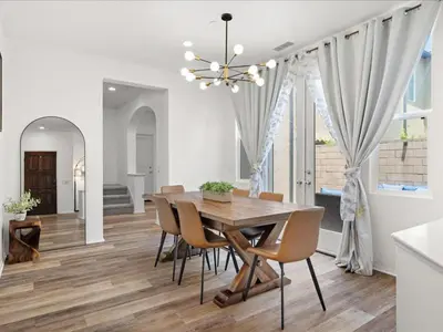 a dining room with a wooden table and chairs at Irvine Inn Love - Lovely Furnished 3-bed Home in Woodbury in Irvine