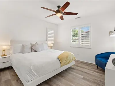 a bedroom with a bed with a ceiling fan at Irvine Inn Love - Lovely Furnished 3-bed Home in Woodbury in Irvine