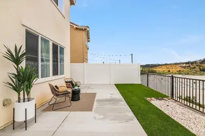 a patio with chairs and a fence and grass at Sunnyside Up San Diego Gem in San Diego