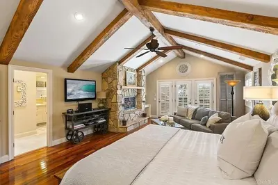 a bedroom with a bed and a living room at Enchanting French Inspired Chateau with Beach Club! in South Oceanside