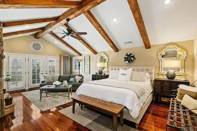 a bedroom with a large bed and a living room at Enchanting French Inspired Chateau with Beach Club! in South Oceanside