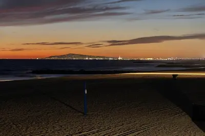 a view of the beach at sunset at Oceanfront 3BR Home with Pool Table & Patio in Newport Beach