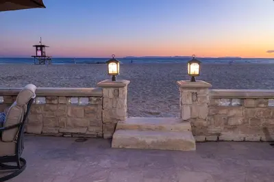 two lights on a stone wall on the beach at Oceanfront 3BR Home with Pool Table & Patio in Newport Beach