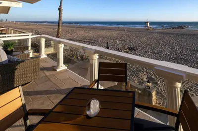 a balcony with a view of the beach at 8BR Beach Duplex with Ocean Views, Patio & Pool Table in Newport Beach