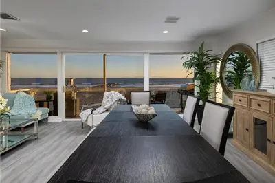 a dining room with a table and a view of the ocean at Spacious 5BR Beach Home with Ocean Views in Newport Beach