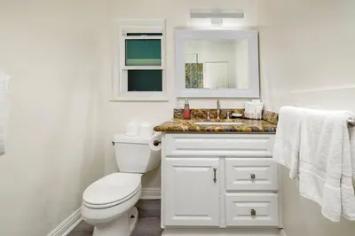 a bathroom with a white toilet and a sink at Spacious 5BR Beach Home with Ocean Views in Newport Beach