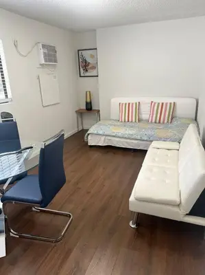 a bedroom with a bed and two chairs and a desk at Fabulous Guesthouse in Mount Helix La Mesa in Grossmont