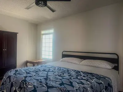 a bedroom with a bed and a ceiling fan at Fabulous Guesthouse in Mount Helix La Mesa in Grossmont