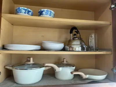 a shelf with bowls and plates and a tea kettle at Fabulous Guesthouse in Mount Helix La Mesa in Grossmont