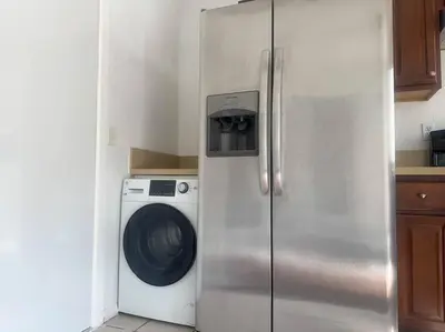 a refrigerator in a kitchen with a washing machine at Fabulous Guesthouse in Mount Helix La Mesa in Grossmont