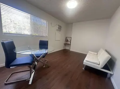 a dining room with a glass table and two chairs at Fabulous Guesthouse in Mount Helix La Mesa in Grossmont