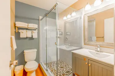 a bathroom with a shower and a toilet and a sink at Hotel Avenida - Oceanside Camp Pendleton in Oceanside