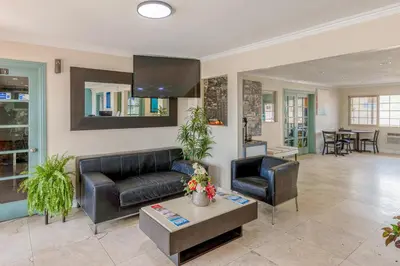 a living room with a couch and a table at Hotel Avenida - Oceanside Camp Pendleton in Oceanside