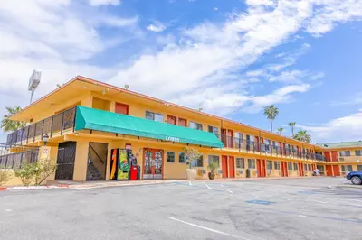 a building with a parking lot in front of it at Hotel Avenida - Oceanside Camp Pendleton in Oceanside