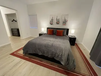 a bedroom with a large bed and two night stands at Cozy Pet-Friendly Residence in Menifee