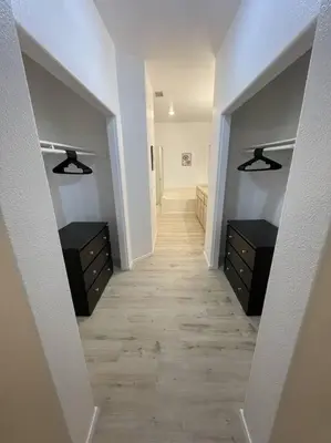a hallway in a house with two dressers and a hallwayngthngthngthngth at Cozy Pet-Friendly Residence in Menifee