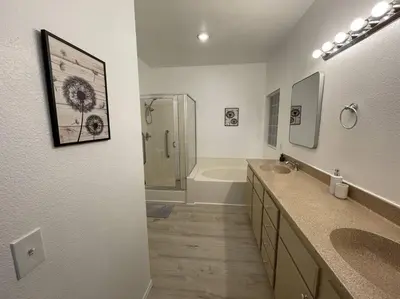 a bathroom with two sinks and a shower at Cozy Pet-Friendly Residence in Menifee