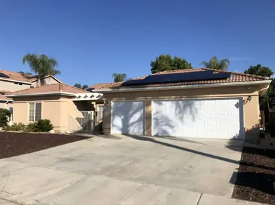 a garage in a house with a driveway at Cozy Pet-Friendly Residence in Menifee