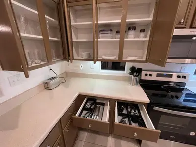 a kitchen with wooden cabinets and a counter top at Cozy Pet-Friendly Residence in Menifee