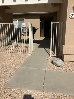 a gate in front of a building with a sign at Cozy Pet-Friendly Residence in Menifee