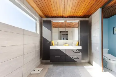 a bathroom with a sink and a mirror at Mid-Century Masterpiece Tree house, Pool & Spa in Escondido