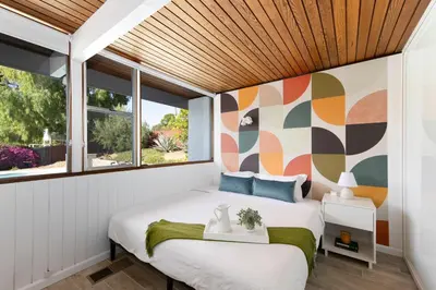 a bedroom with a bed and a window at Mid-Century Masterpiece Tree house, Pool & Spa in Escondido