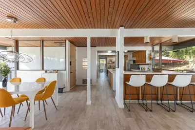 a kitchen and dining room with a table and chairs at Mid-Century Masterpiece Tree house, Pool & Spa in Escondido