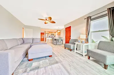 a living room with a couch and a table at Newport Beach Condo with Patio Perfect Location on the Boardwalk in Newport Beach