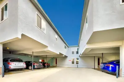 a large parking lot with cars parked in it at Newport Beach Condo with Patio Perfect Location on the Boardwalk in Newport Beach