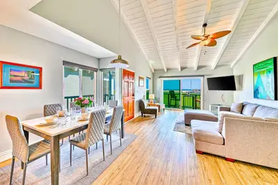a living room with a table and chairs and a couch at Condo in Newport Beach with Private Balcony and Ideal Location by the Pier in Newport Beach